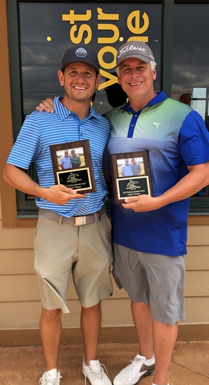 Adam Kasick at a golf event holding an award