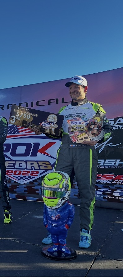 Adam Kasick at a racing podium